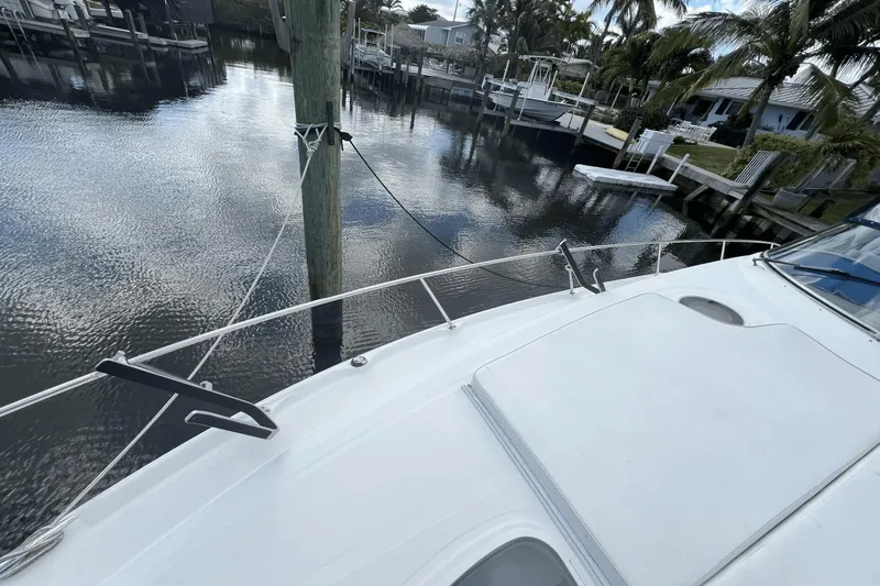 Slide: The Image of 2005 Sea Ray 340 Sundancer docked in a serene marina setting. - 5