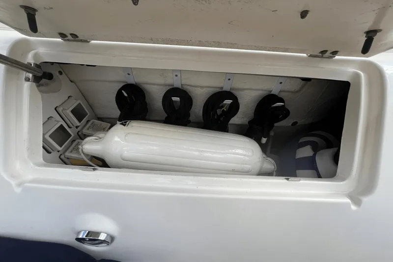 Slide: The Image of Storage compartment on a 2005 Sea Ray 340 Sundancer boat with fenders and ropes. - 14