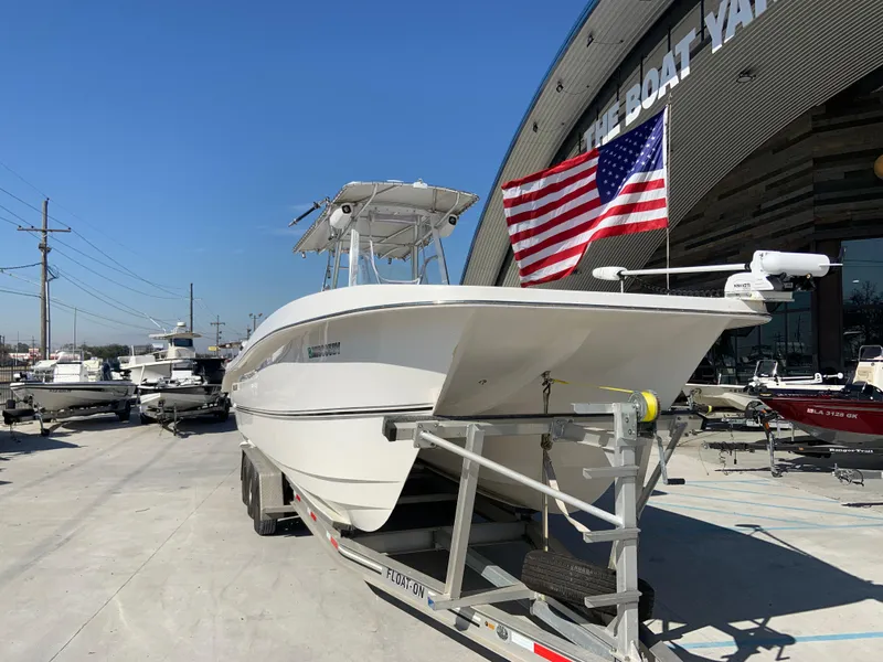 Slide: The Image of 2018 Twin Vee 310 GF boat on trailer at The Boat Yard with American flag. - 12