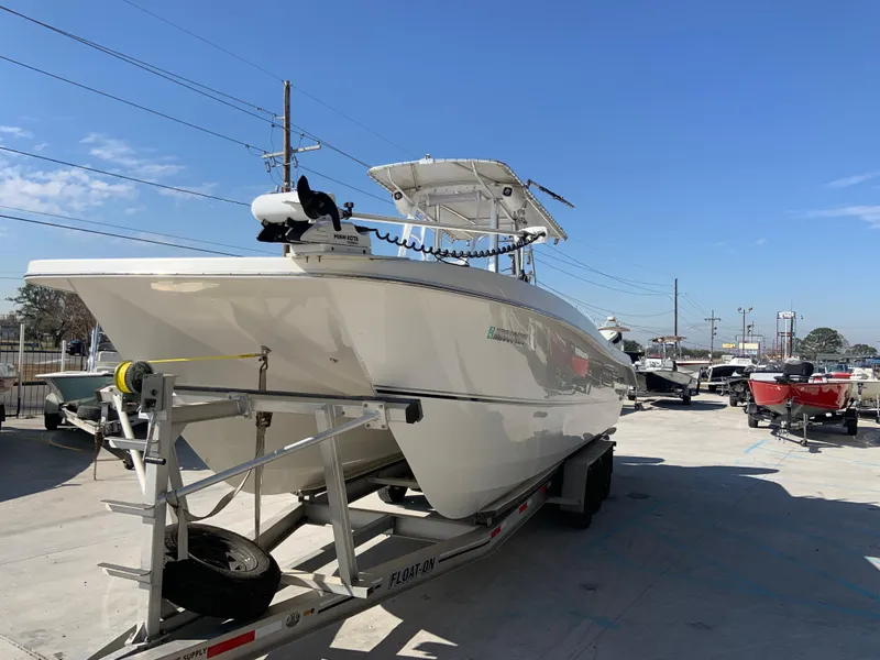 Slide: The Image of 2018 Twin Vee 310 GF boat on trailer in a marina. - 13