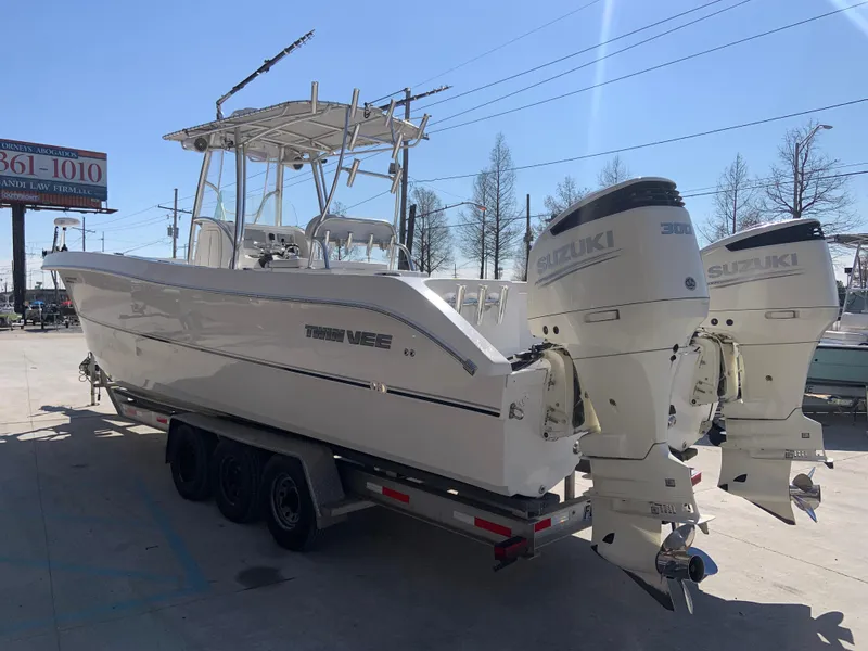Slide: The Image of 2018 Twin Vee 310 GF boat with twin Suzuki 300 outboard engines on trailer. - 14