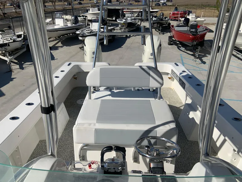 Slide: The Image of 2018 Twin Vee 310 GF boat interior with steering wheel and seating. - 4