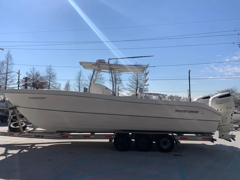 Slide: The Image of 2018 Twin Vee 310 GF boat on trailer with Suzuki outboard motors. - 8