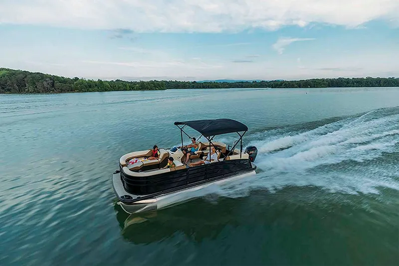 Slide: The Image of 2024 Lowe SS210 WT pontoon boat cruising on a serene lake. - 17