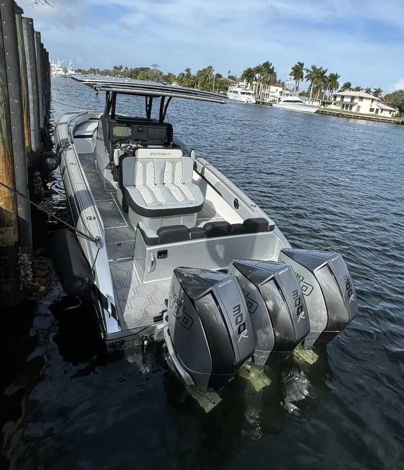 Slide: The Image of 2024 Statement 350 boat docked with triple outboard engines. - 1