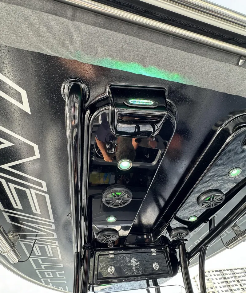 Slide: The Image of 2024 Statement 350 boat with sleek black interior and green LED lights. - 11