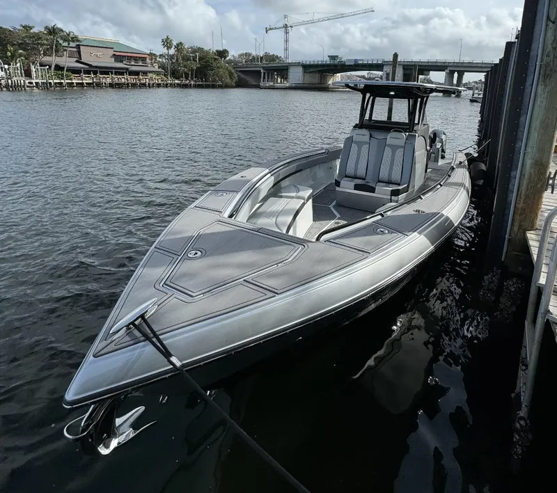 Slide: The Image of 2024 Statement 350 boat docked by the water. - 2