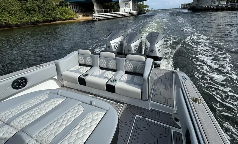 Slide: The Image of 2024 Statement 350 boat with triple outboard engines cruising on water. - 3
