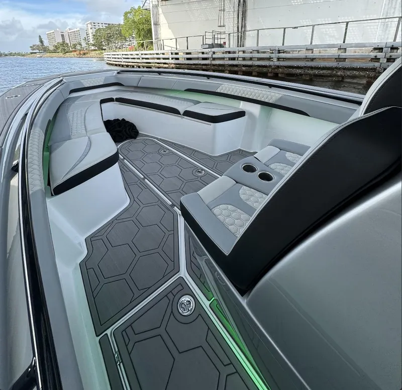 Slide: The Image of 2024 Statement 350 boat interior with modern seating and geometric flooring design. - 4
