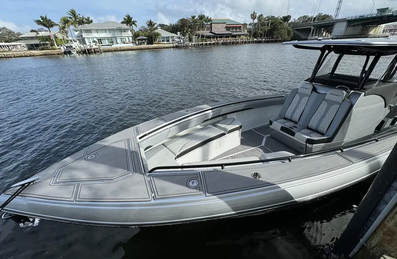 Slide: The Image of 2024 Statement 350 boat docked by waterfront homes. - 5