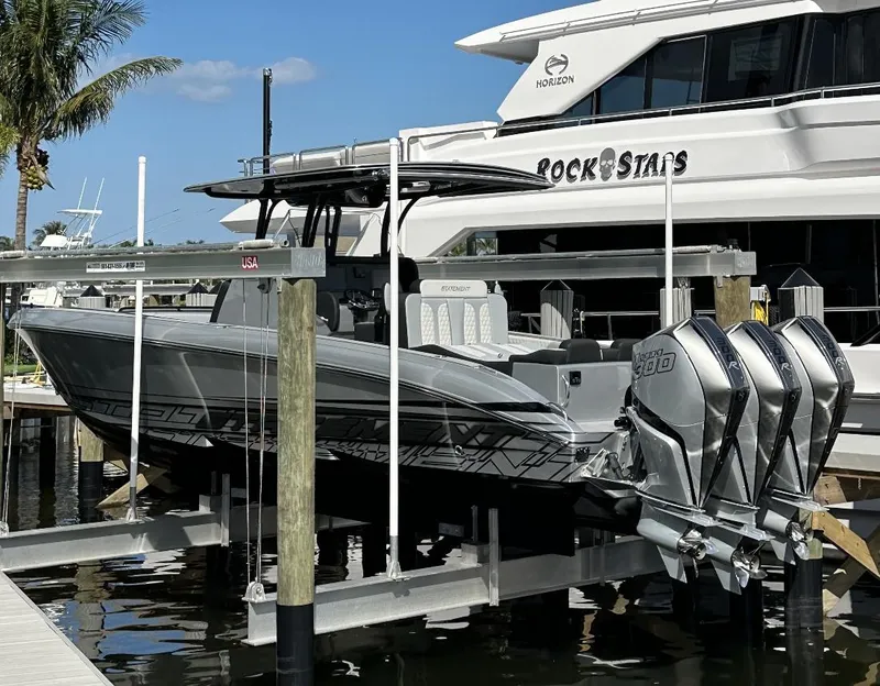 Slide: The Image of 2024 Statement 350 boat with triple outboard engines docked at marina. - 7