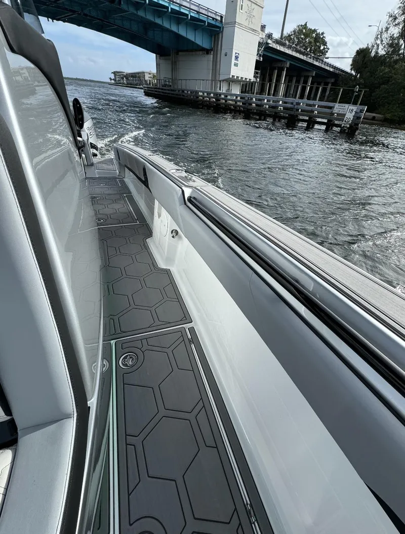 Slide: The Image of 2024 Statement 350 boat cruising under a bridge on a river. - 8