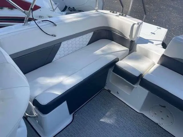 Slide: The Image of 2024 Hurricane 218 SS boat interior with white and gray seating. - 3