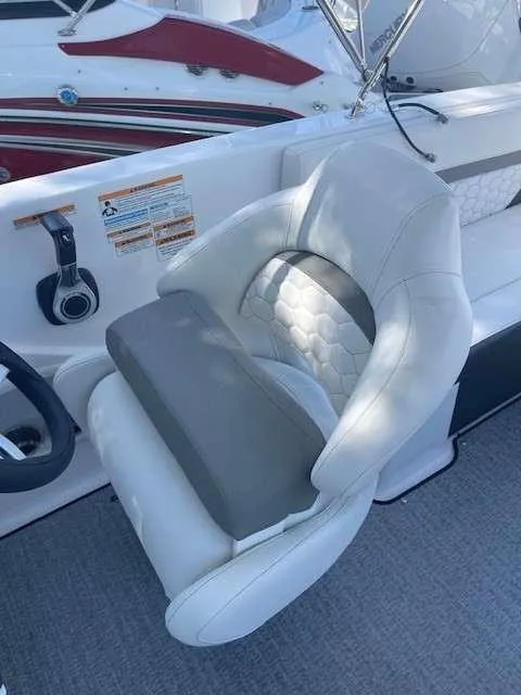 Slide: The Image of 2024 Hurricane 218 SS boat interior with white and gray captain's chair. - 4