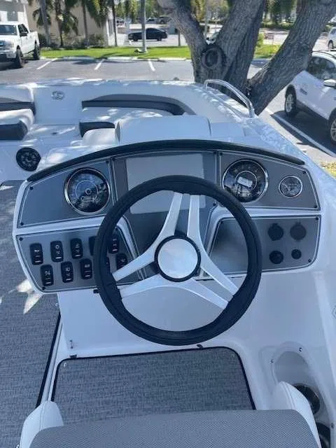 Slide: The Image of 2024 Hurricane 218 SS boat dashboard with steering wheel and control panel. - 5