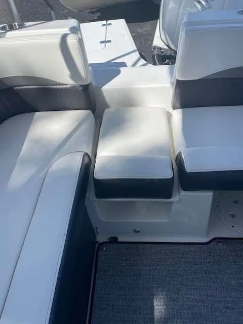 Slide: The Image of 2024 Hurricane 218 SS boat interior with white and gray cushioned seating. - 7