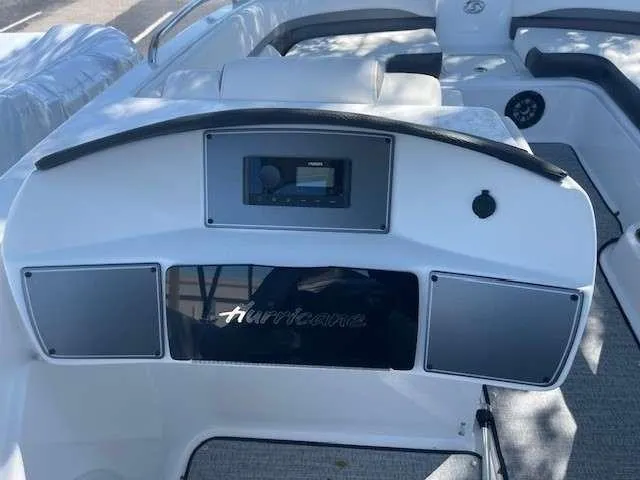 Slide: The Image of 2024 Hurricane 218 SS boat dashboard with stereo system and seating. - 8