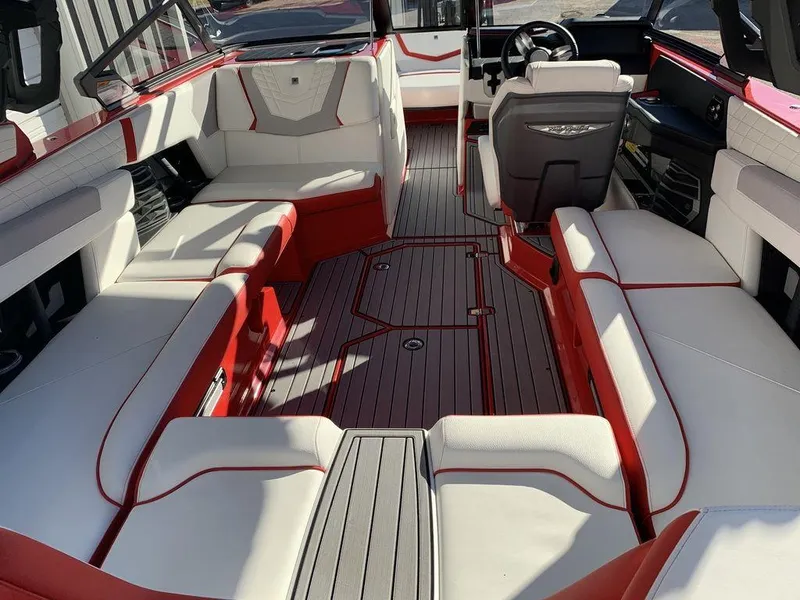 Slide: The Image of 2024 Nautique Super Air Nautique G23 interior with red and white seating. - 2