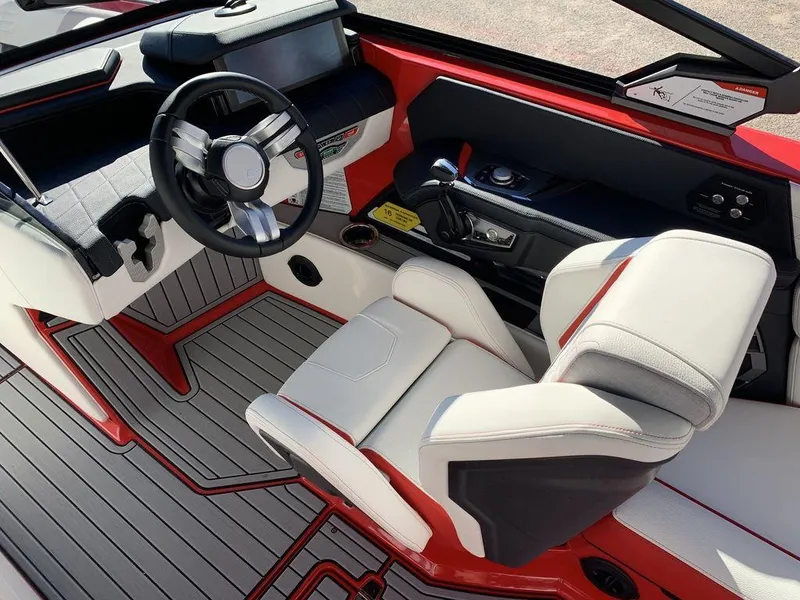 Slide: The Image of 2024 Nautique Super Air Nautique G23 cockpit with modern steering wheel and luxurious seating. - 3