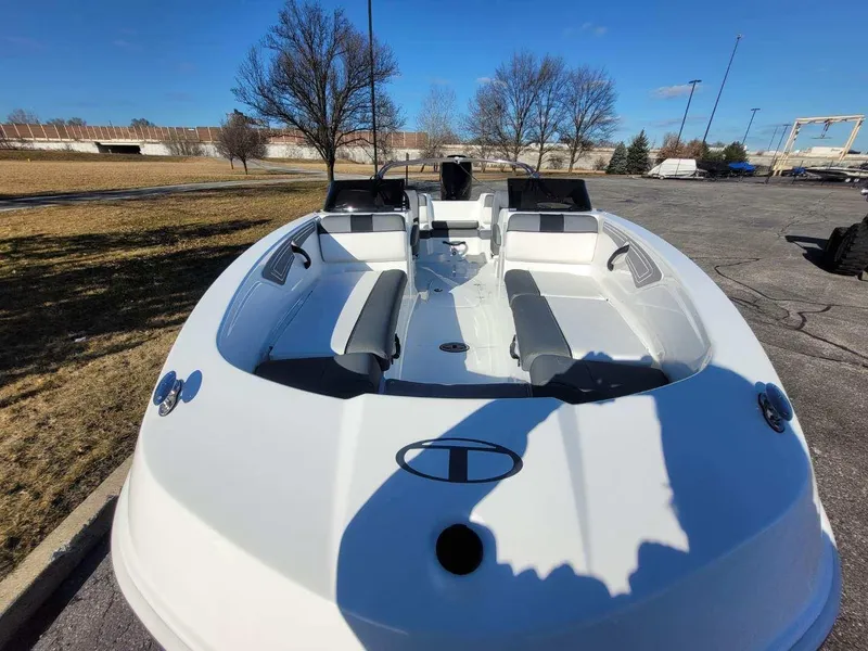 Slide: The Image of 2024 Tahoe T21 boat with spacious seating, parked outdoors on a sunny day. - 4