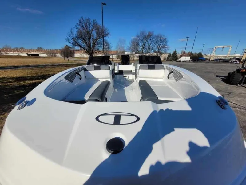 Slide: The Image of 2024 Tahoe T21 boat with spacious seating, parked outdoors on a sunny day. - 5