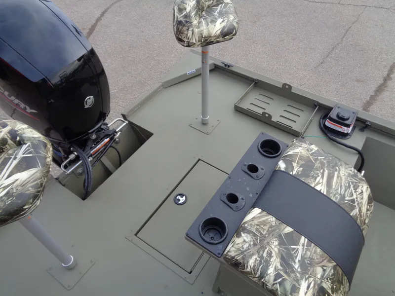 Slide: The Image of 2024 Tracker Grizzly 2072 CC Sportsman boat interior with camo seats and Mercury outboard motor. - 14