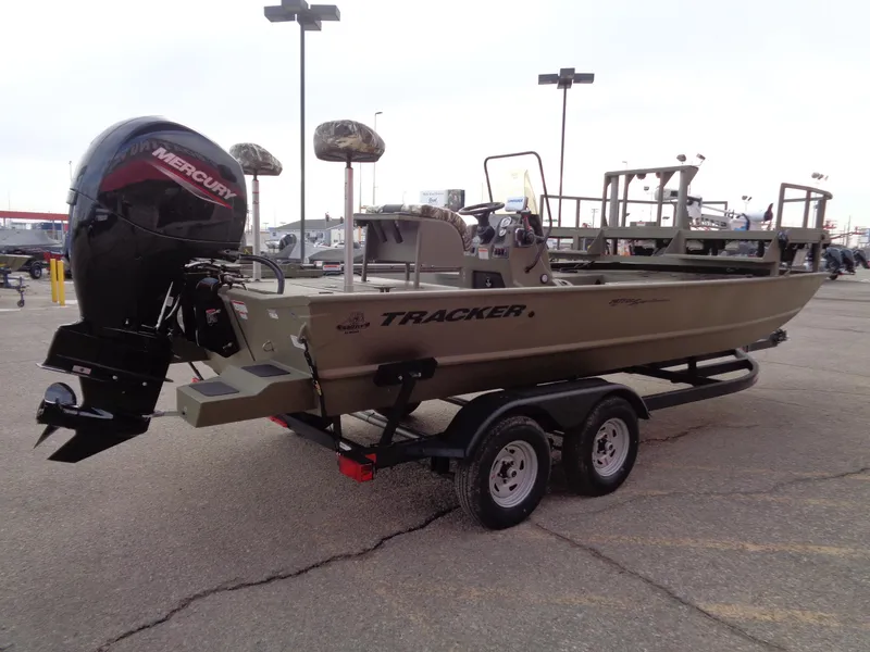Slide: The Image of 2024 Tracker Grizzly 2072 CC Sportsman boat on trailer with Mercury outboard motor. - 3