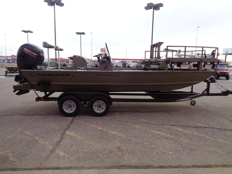 Slide: The Image of 2024 Tracker Grizzly 2072 CC Sportsman boat on a trailer in a parking lot. - 4