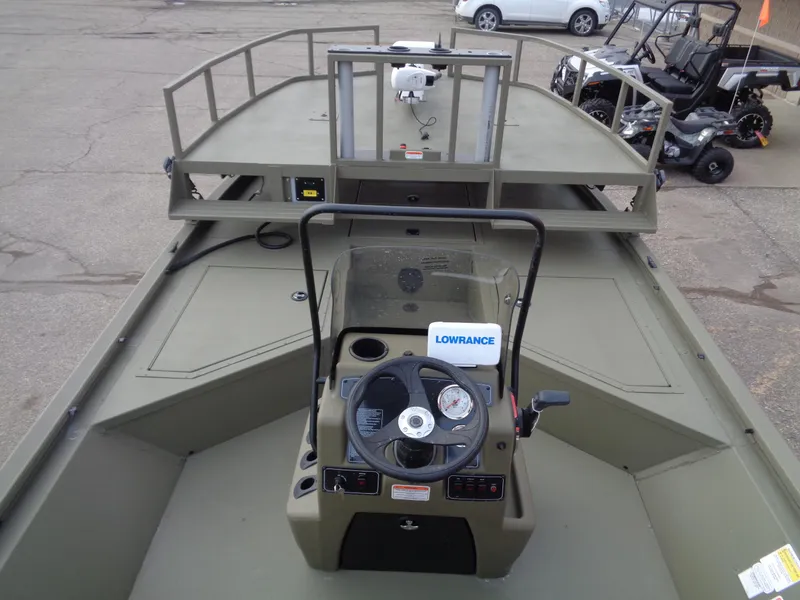 Slide: The Image of 2024 Tracker Grizzly 2072 CC Sportsman boat interior with steering console and deck. - 6