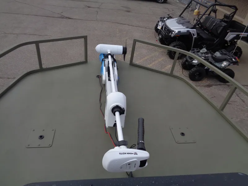 Slide: The Image of 2024 Tracker Grizzly 2072 CC Sportsman boat with mounted trolling motor. - 9