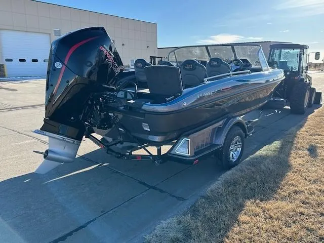Slide: The Image of 2024 Ranger 1880MS boat on trailer with outboard motor, parked outdoors. - 2