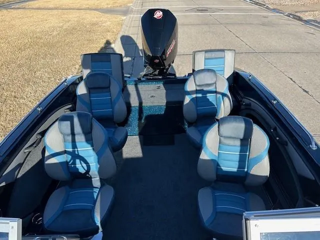 Slide: The Image of 2024 Ranger 1880MS boat interior with six blue and gray seats and an outboard motor. - 7