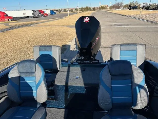 Slide: The Image of 2024 Ranger 1880MS boat with blue and gray seats and Mercury outboard motor. - 8