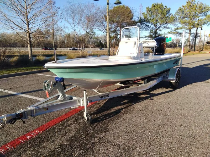 Slide: The Image of 2024 Mako 18 LTS boat on trailer in outdoor setting. - 1