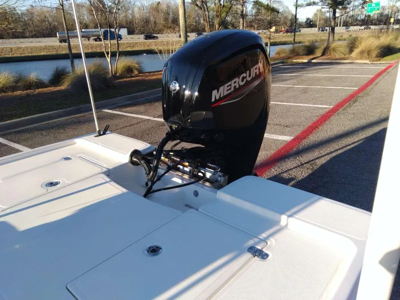 Slide: The Image of 2024 Mako 18 LTS boat with Mercury outboard motor in parking lot. - 11