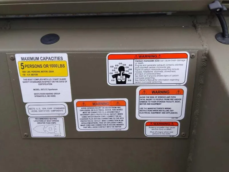 Slide: The Image of Warning labels and capacity information on a 2024 Tracker Grizzly 2072 CC Sportsman boat. - 10