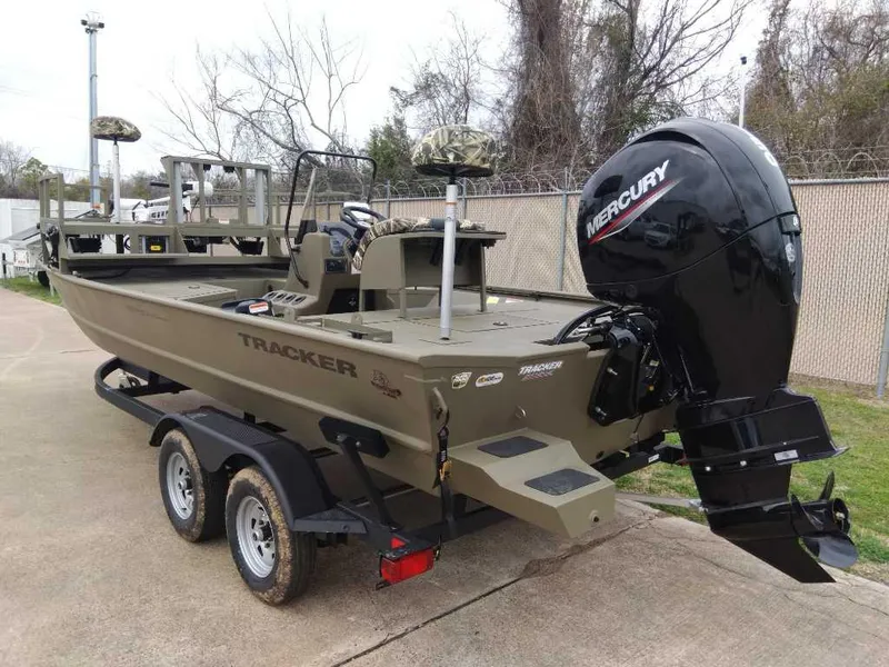 Slide: The Image of 2024 Tracker Grizzly 2072 CC Sportsman boat with Mercury outboard engine on trailer. - 3