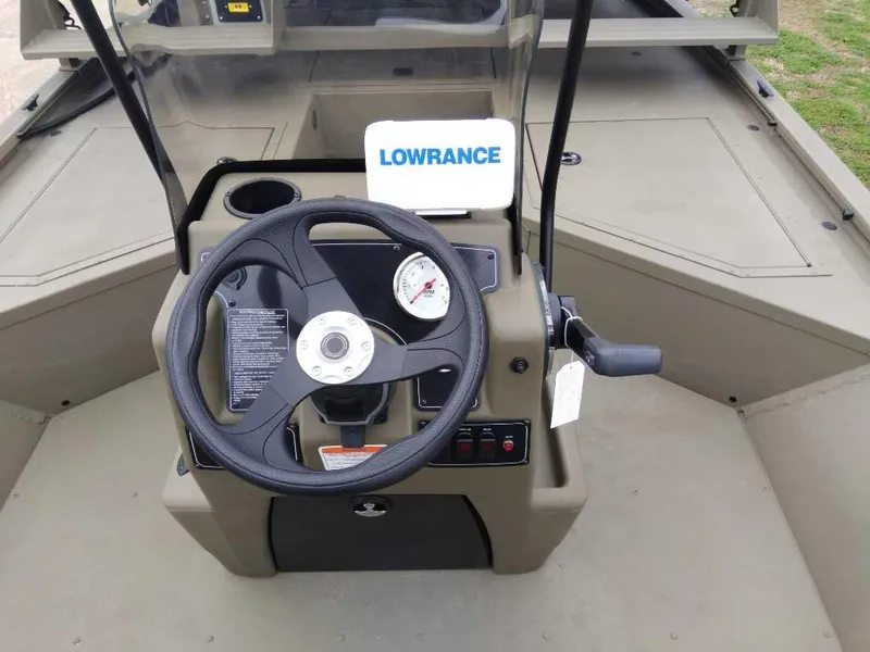 Slide: The Image of 2024 Tracker Grizzly 2072 CC Sportsman boat console with steering wheel and Lowrance fishfinder. - 4