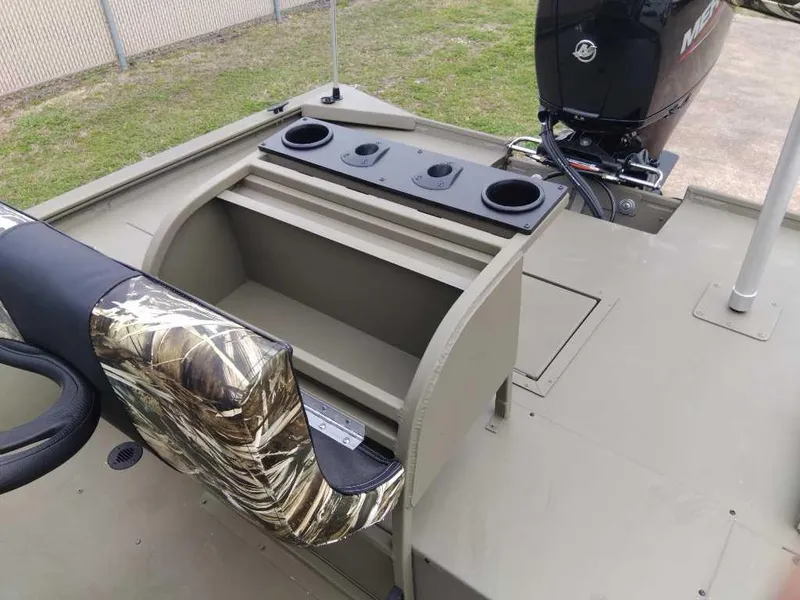 Slide: The Image of 2024 Tracker Grizzly 2072 CC Sportsman boat interior with camo seat and storage compartments. - 5