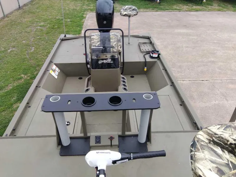 Slide: The Image of 2024 Tracker Grizzly 2072 CC Sportsman boat interior with console and seating. - 8