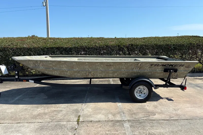 The Image of 2024 Tracker Grizzly 1754 Jon boat on trailer, parked outdoors. - 0