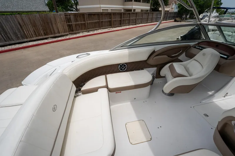 Slide: The Image of 2011 Cobalt 242 boat interior with white and brown seating. - 14