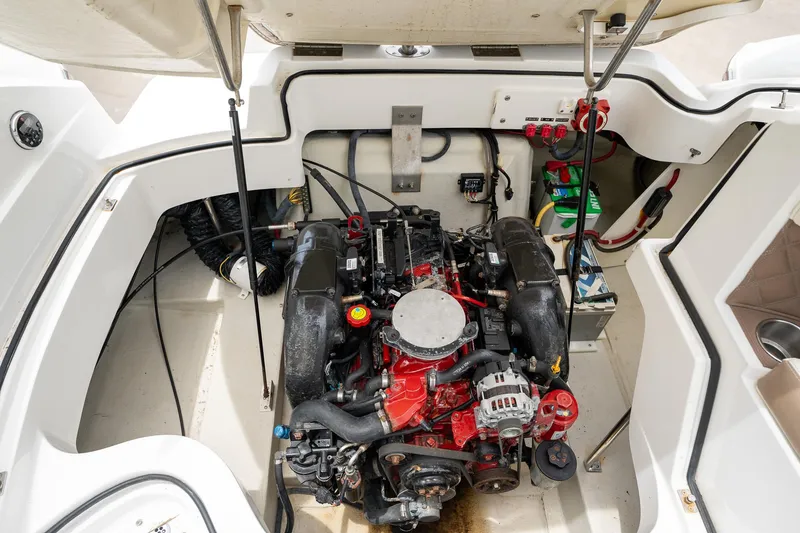 Slide: The Image of Engine compartment of a 2011 Cobalt 242 boat with visible engine and components. - 19