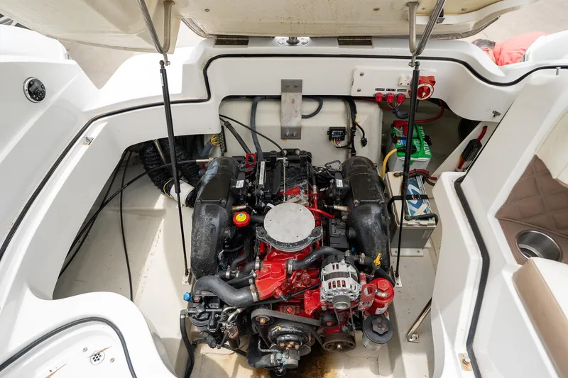 Slide: The Image of 2011 Cobalt 242 boat engine compartment with visible engine and wiring. - 20