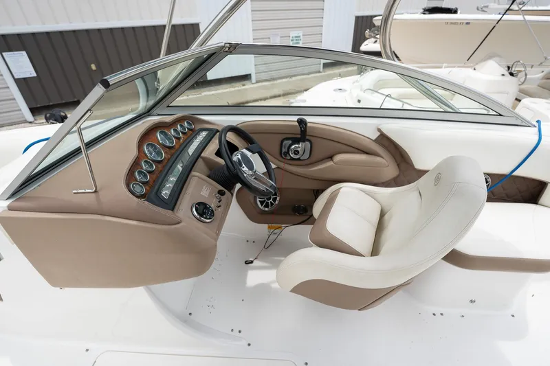 Slide: The Image of 2011 Cobalt 242 boat cockpit with steering wheel and dashboard. - 22
