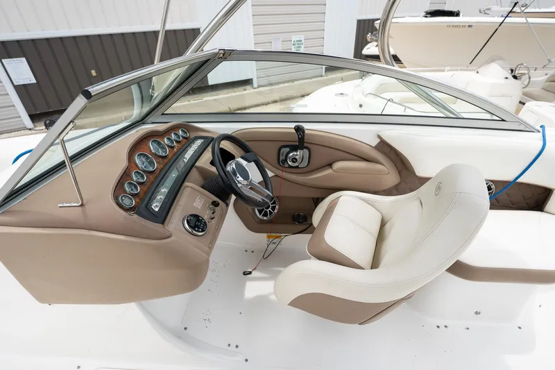 Slide: The Image of 2011 Cobalt 242 boat cockpit with steering wheel and control panel. - 23