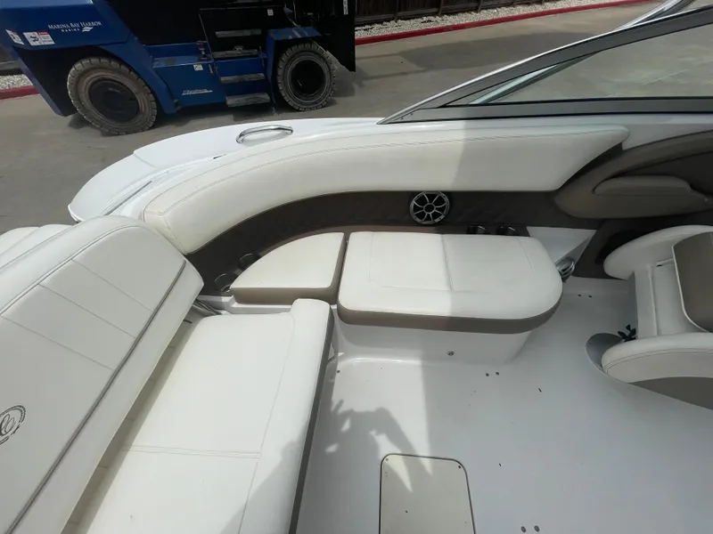 Slide: The Image of 2011 Cobalt 242 boat interior with white seating and speaker. - 28