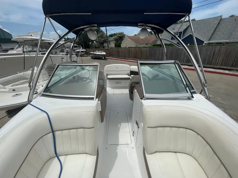 Slide: The Image of 2011 Cobalt 242 boat with white interior and blue canopy. - 34