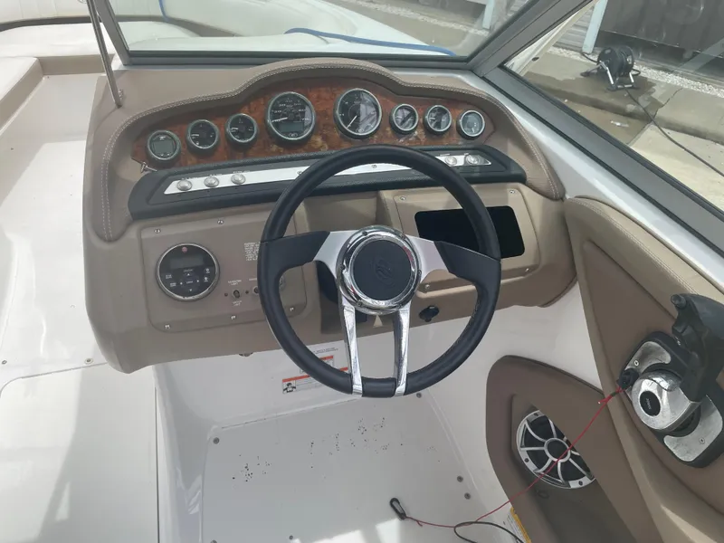 Slide: The Image of 2011 Cobalt 242 boat dashboard with steering wheel and instrument panel. - 35