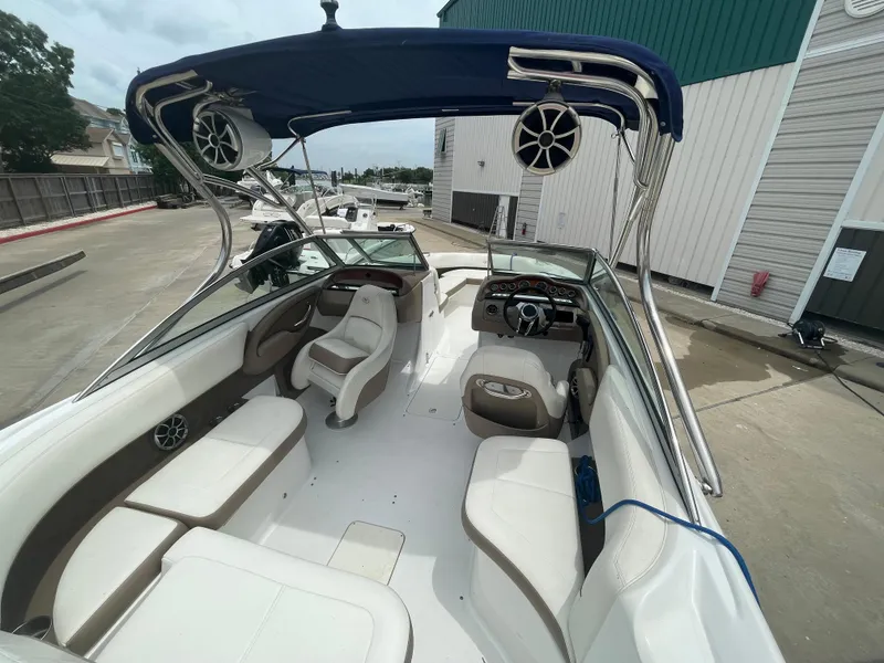Slide: The Image of 2011 Cobalt 242 boat with spacious seating and blue canopy. - 39